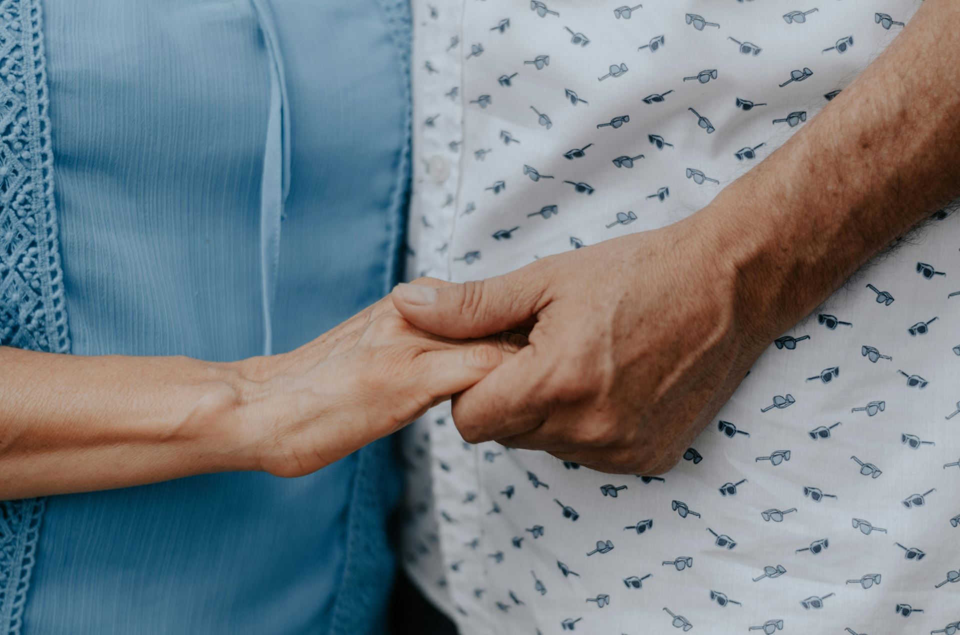 photo of older people holding hands