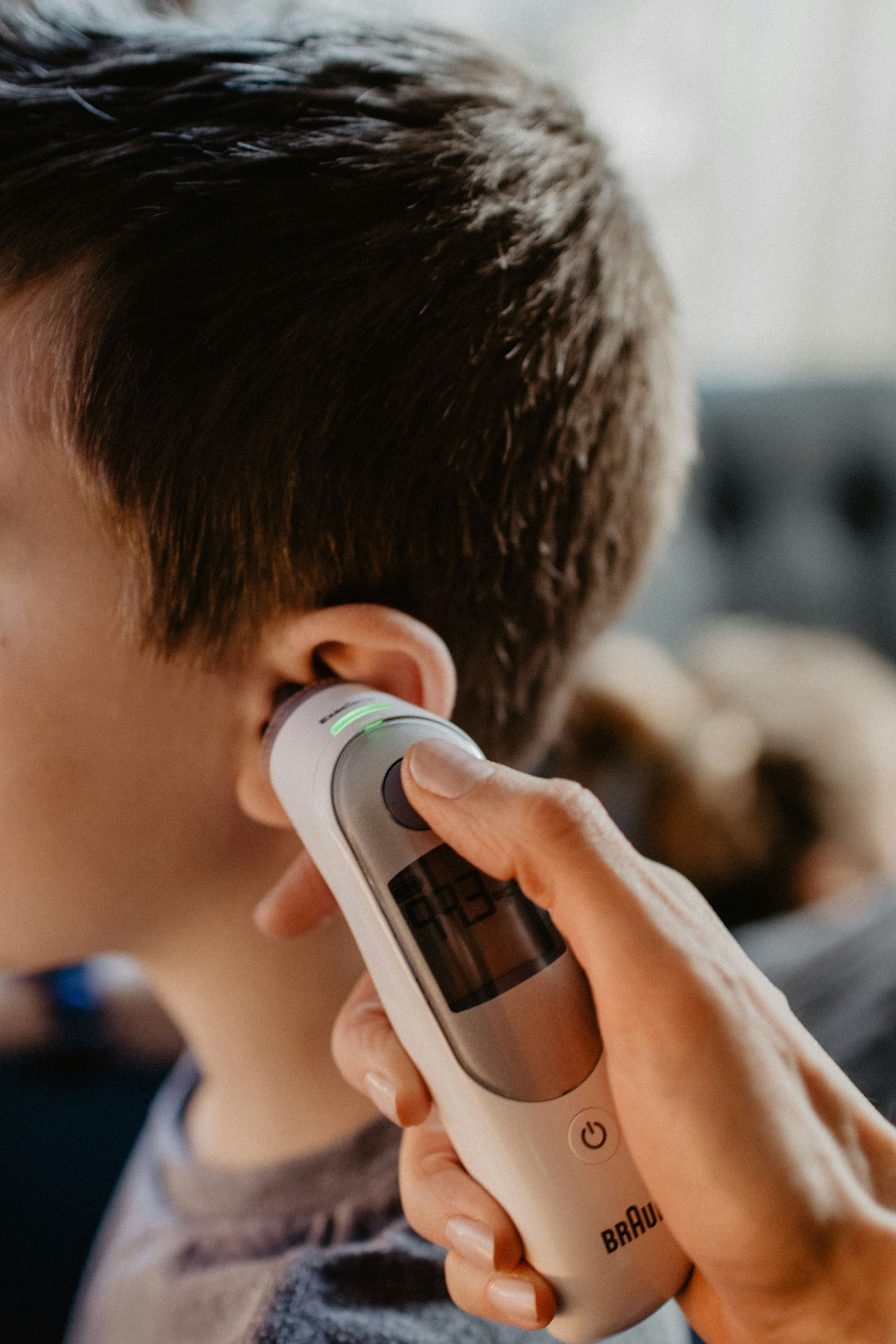 boy getting a temperature reading