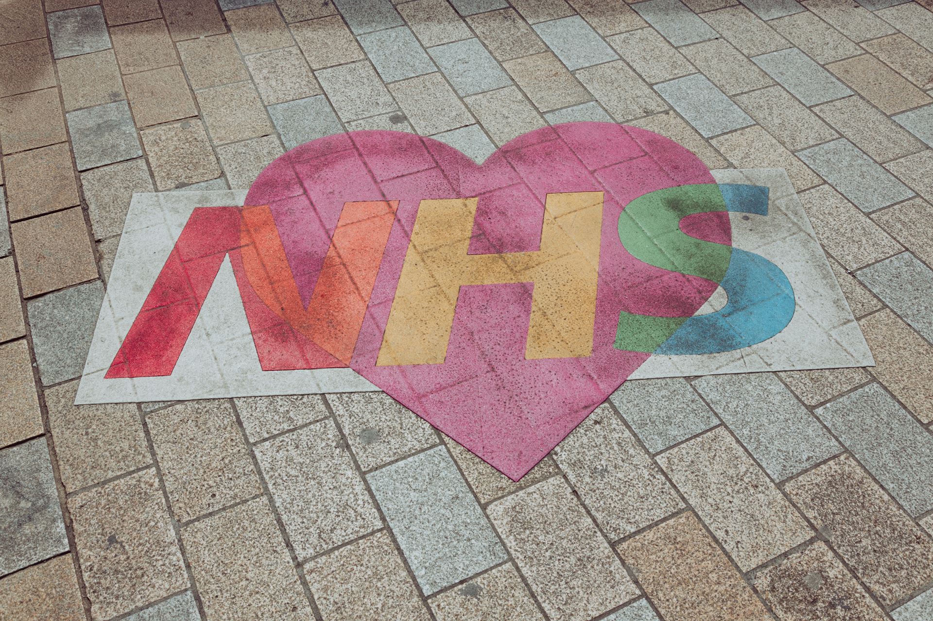 photo of a chalk drawing with the letters 'NHS'